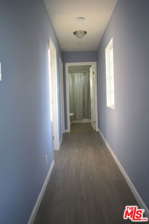 hall with dark hardwood / wood-style floors