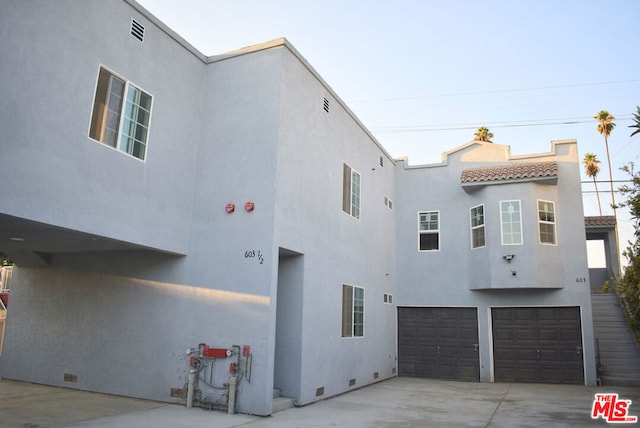 view of side of property featuring a garage