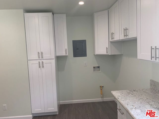 laundry room with washer hookup, dark hardwood / wood-style flooring, cabinets, and electric panel