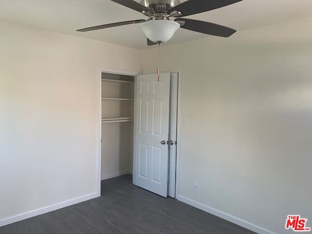 unfurnished bedroom with a closet, ceiling fan, and dark wood-type flooring