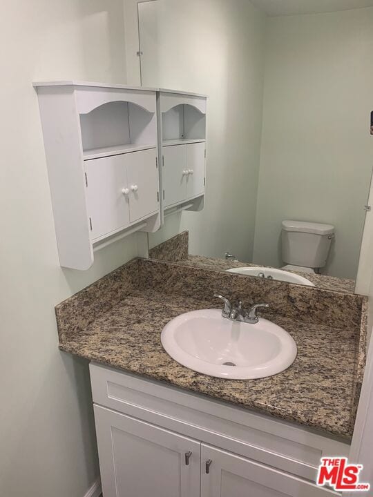 bathroom with vanity and toilet