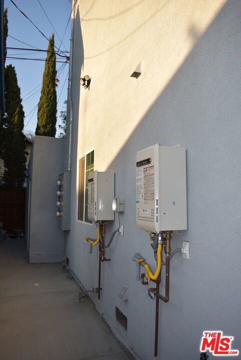 utility room with tankless water heater