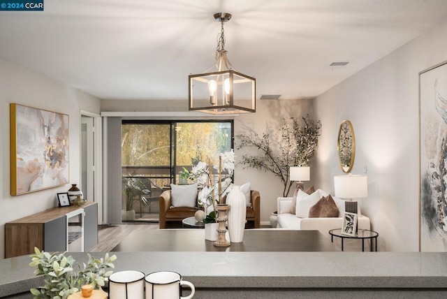 living room featuring hardwood / wood-style flooring and a notable chandelier