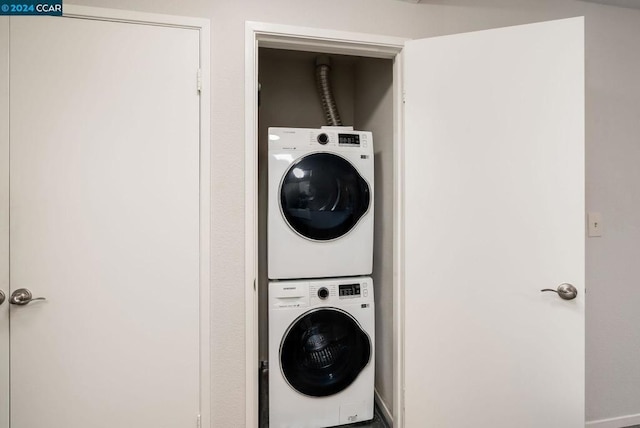 laundry area featuring stacked washer / drying machine