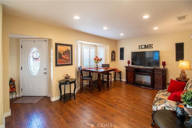 living room with dark hardwood / wood-style flooring