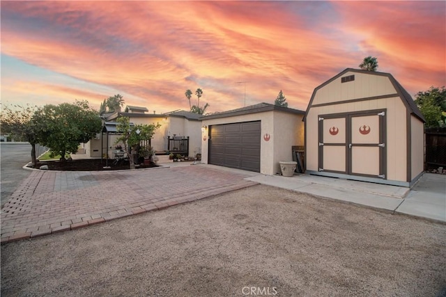 view of front of home featuring a storage shed