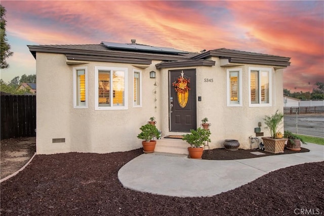 view of front of property with solar panels