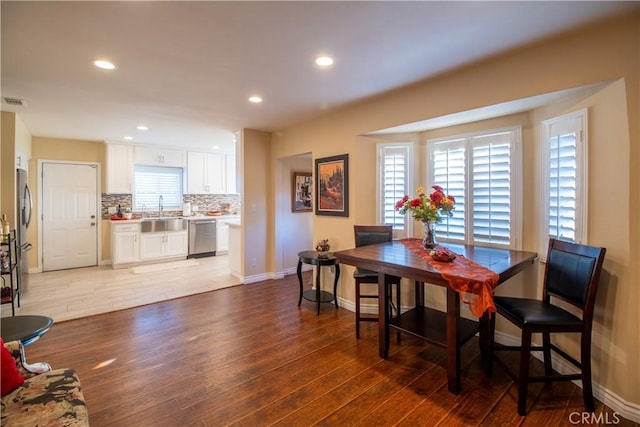 dining room featuring light wood-type flooring and sink