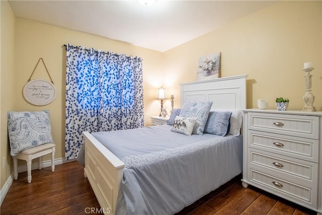 bedroom with dark wood-type flooring