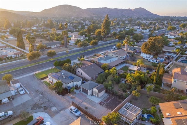 aerial view at dusk featuring a mountain view