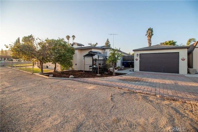 view of front of property featuring a gazebo and a garage