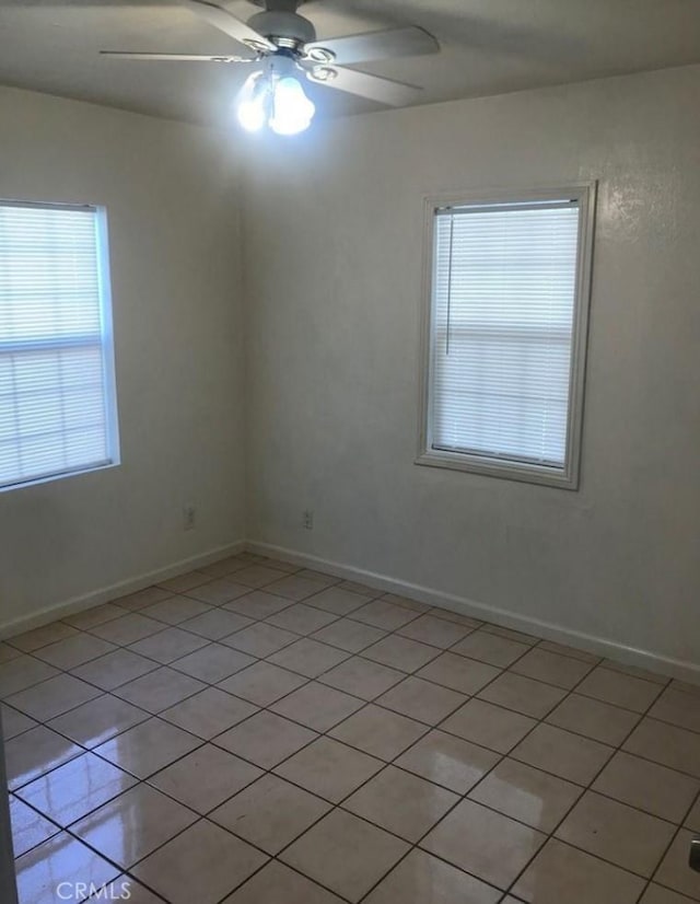 unfurnished room with ceiling fan and light tile patterned floors