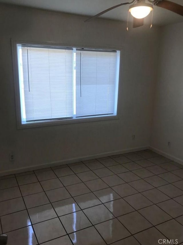 tiled spare room featuring plenty of natural light