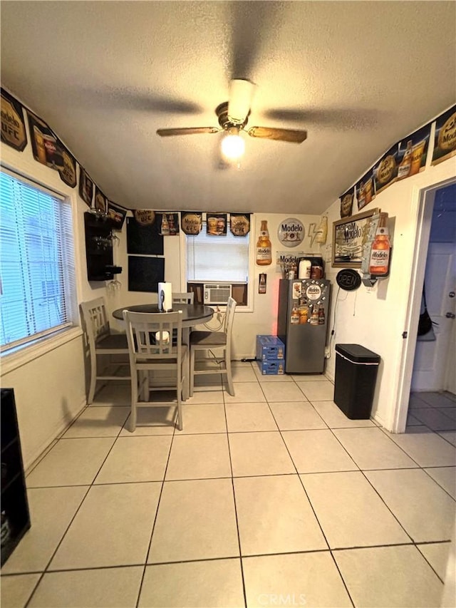 dining room with a textured ceiling, tile patterned floors, ceiling fan, and cooling unit