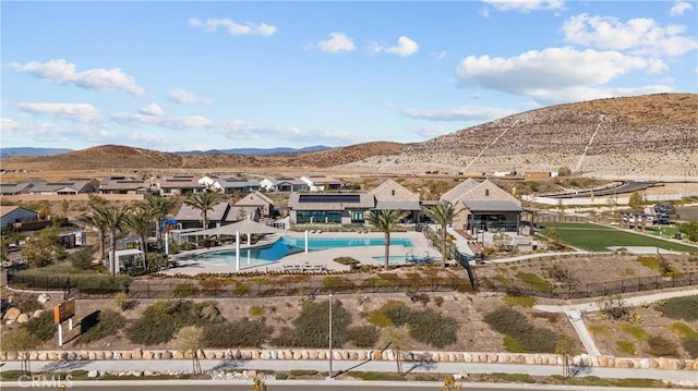 view of swimming pool with a mountain view