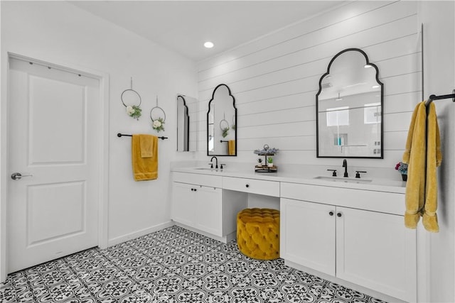 bathroom featuring vanity and wooden walls