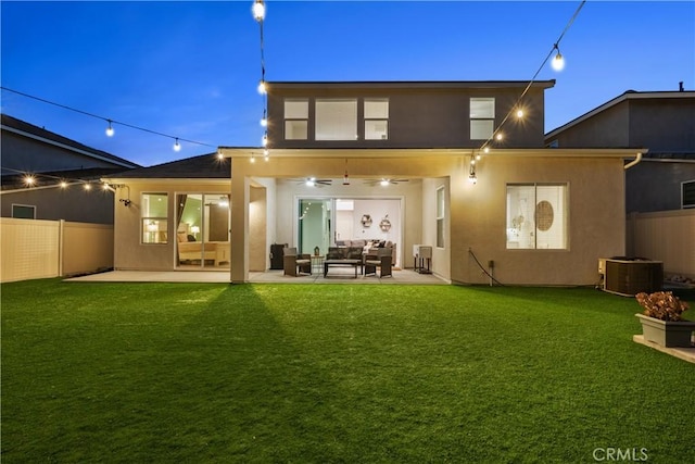 back of house featuring a lawn, ceiling fan, a patio area, and an outdoor hangout area