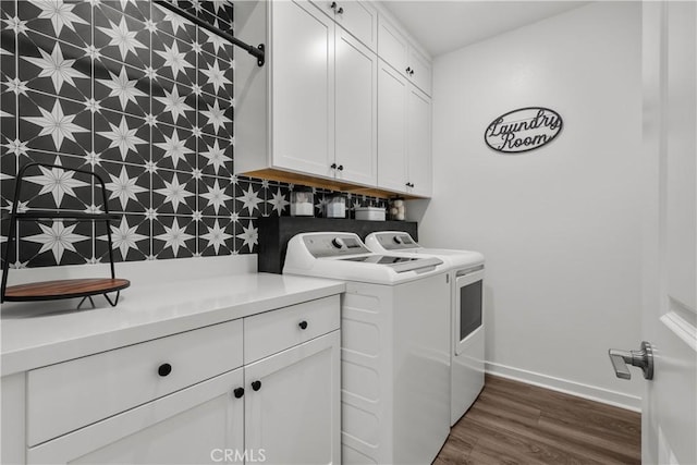 laundry room with dark hardwood / wood-style floors, cabinets, tile walls, and washing machine and clothes dryer