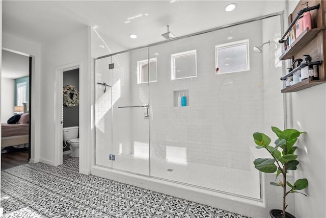 bathroom with tile patterned flooring, toilet, and a shower with shower door