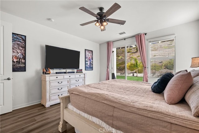 bedroom with access to exterior, ceiling fan, and dark wood-type flooring