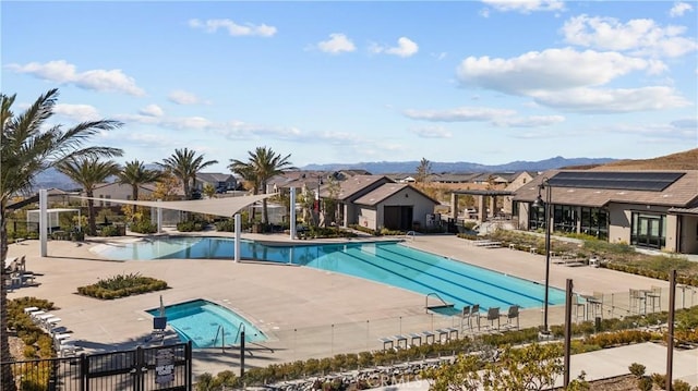 view of swimming pool featuring a patio area and a mountain view