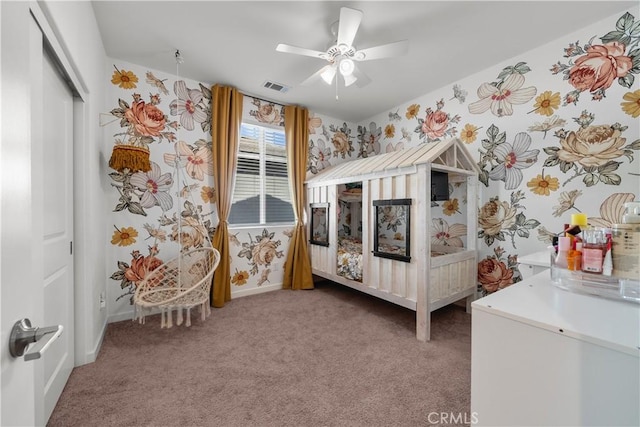 carpeted bedroom with ceiling fan and a closet