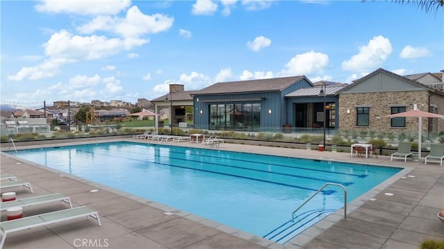 view of swimming pool with a patio area