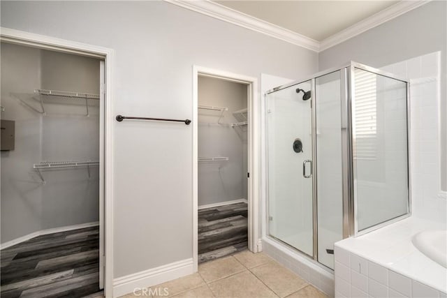 bathroom with shower with separate bathtub, wood-type flooring, and crown molding