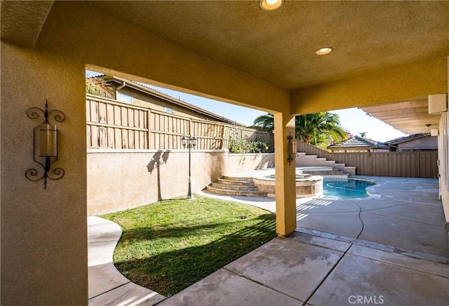 view of patio with a swimming pool with hot tub