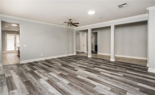 basement with ornamental molding and dark wood-type flooring