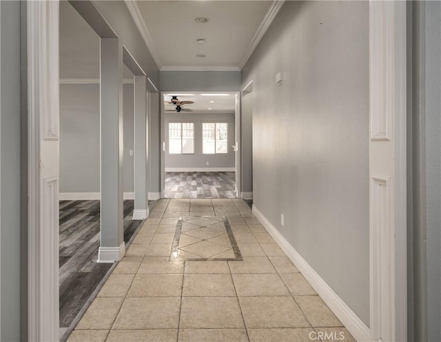 corridor featuring crown molding and light hardwood / wood-style flooring