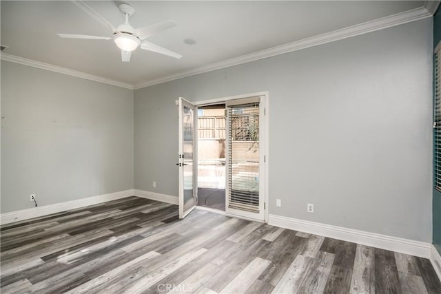 empty room featuring ceiling fan, wood-type flooring, and crown molding