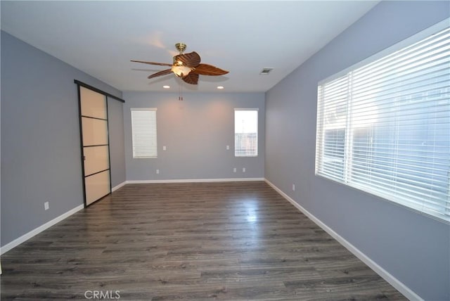 empty room featuring dark hardwood / wood-style floors and ceiling fan