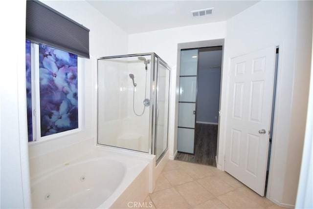 bathroom featuring tile patterned floors and independent shower and bath