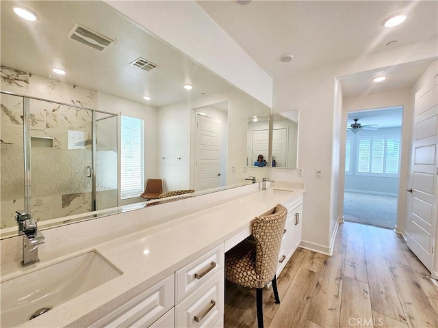 bathroom featuring an enclosed shower, vanity, wood-type flooring, and plenty of natural light