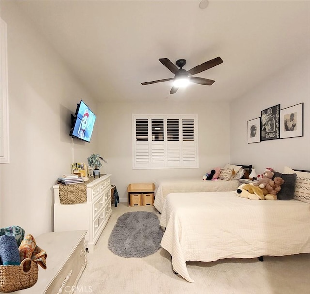 bedroom with light colored carpet and ceiling fan