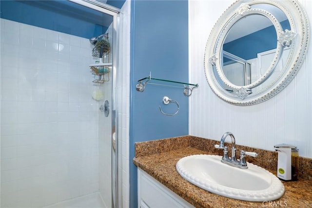 bathroom with vanity and a shower with shower door