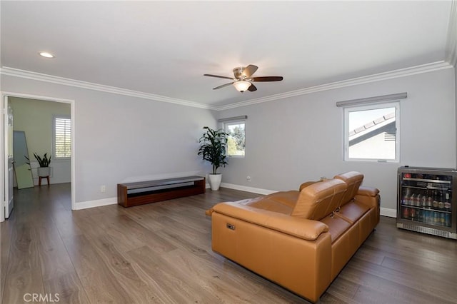 living room featuring hardwood / wood-style flooring, ceiling fan, ornamental molding, and heating unit