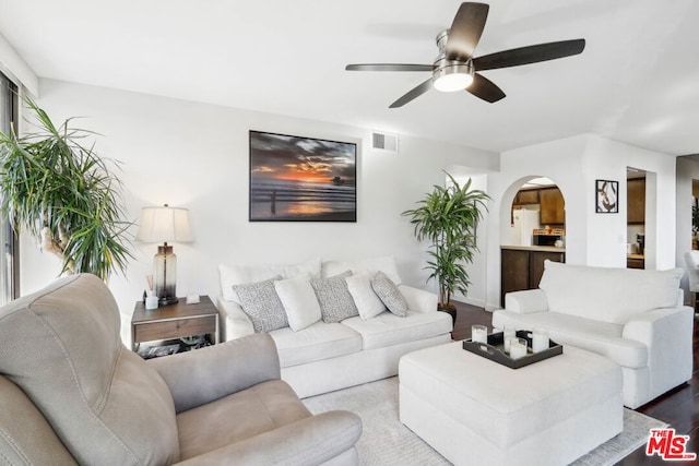 living room with light hardwood / wood-style flooring and ceiling fan