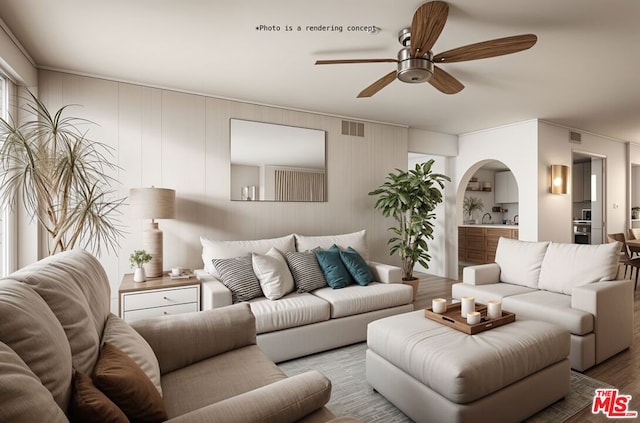 living room featuring wood-type flooring and ceiling fan