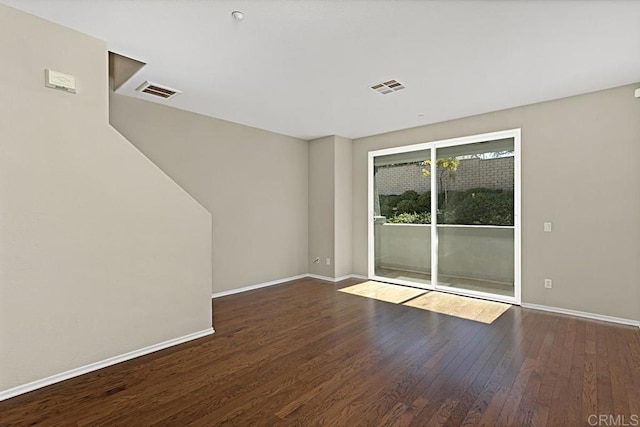 empty room with dark wood-type flooring