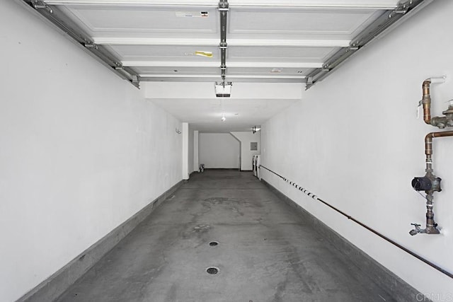 garage featuring a garage door opener and a baseboard heating unit