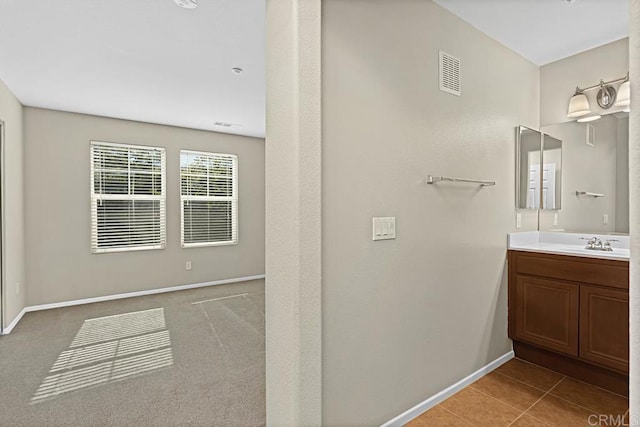 bathroom featuring tile patterned flooring and vanity