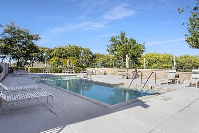 view of swimming pool with a patio