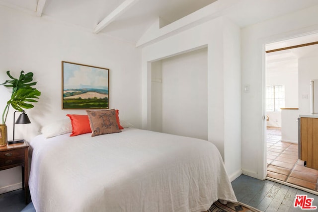 bedroom featuring hardwood / wood-style floors and beamed ceiling