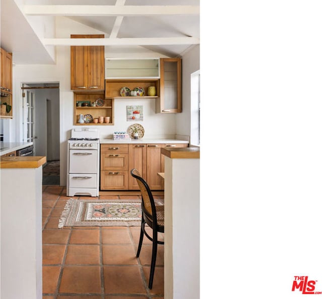 kitchen with beamed ceiling and white stove