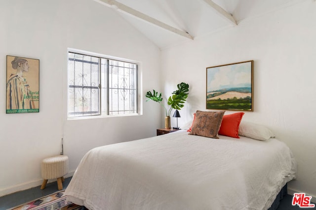 bedroom featuring vaulted ceiling with beams