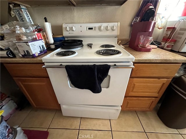 kitchen featuring white electric range oven and light tile patterned floors