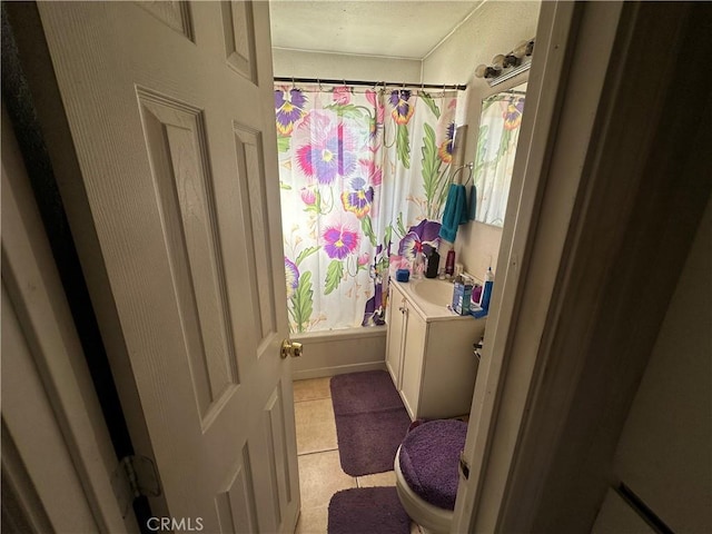 full bathroom featuring tile patterned flooring, shower / tub combo, vanity, and toilet