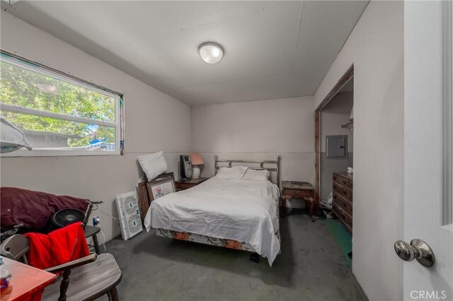 bedroom featuring electric panel and dark carpet